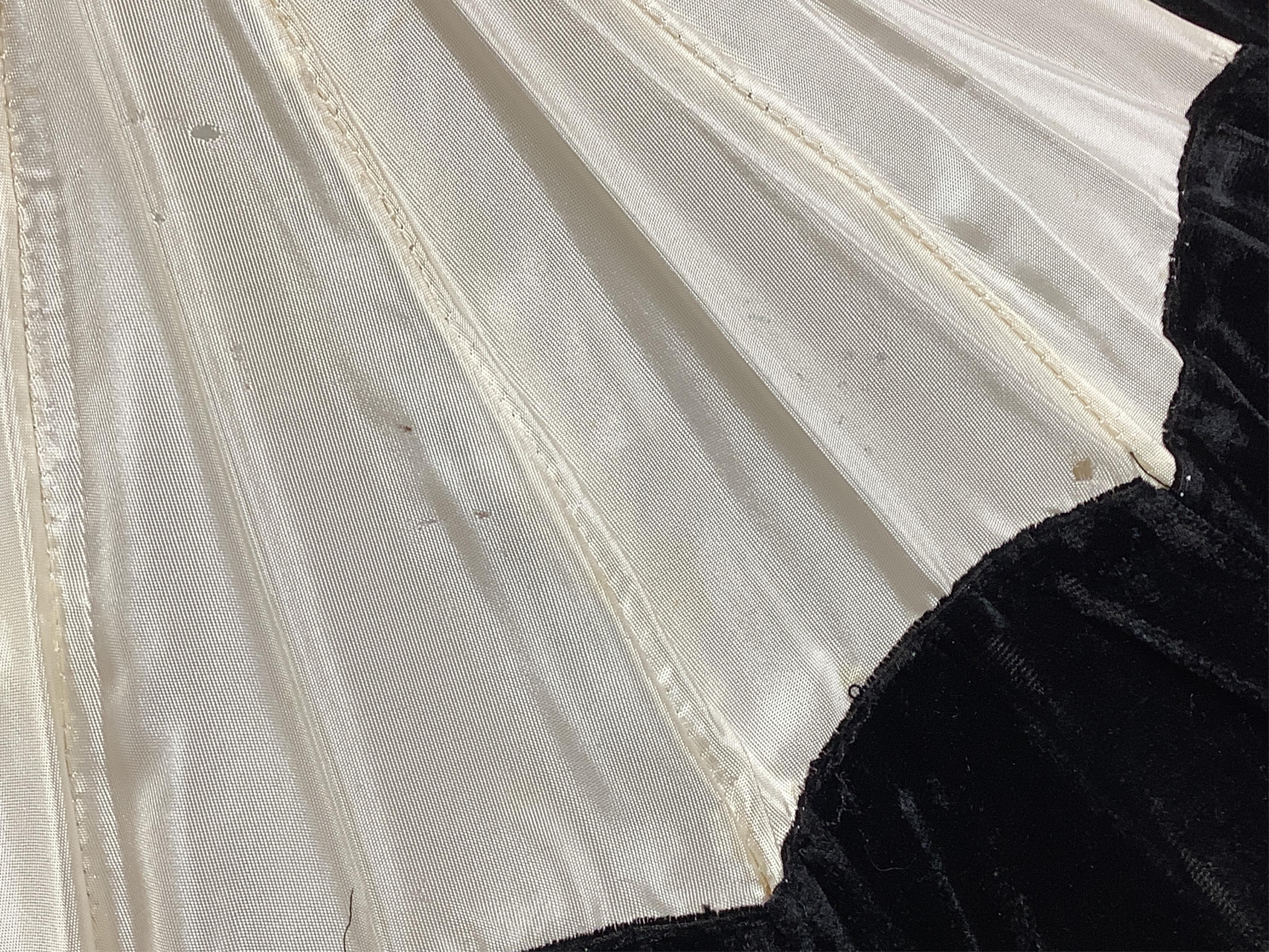 An unusual early 20th century cream silk and black velvet parasol and silk corded tassel. 64cm high. Condition - good